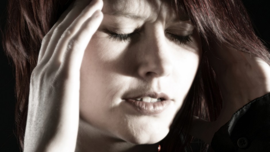 Žena si drží hlavu v dlaniach